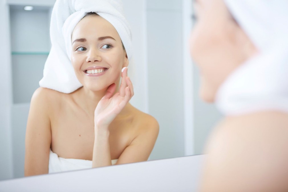 Girl applying face cream